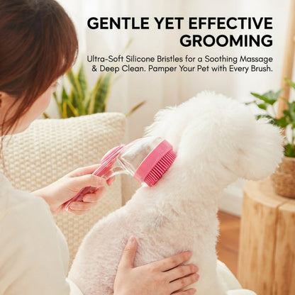 A small fluffy white dog gets brushed indoors with a pink bath massage brush and shampoo dispenser in a bright living room.