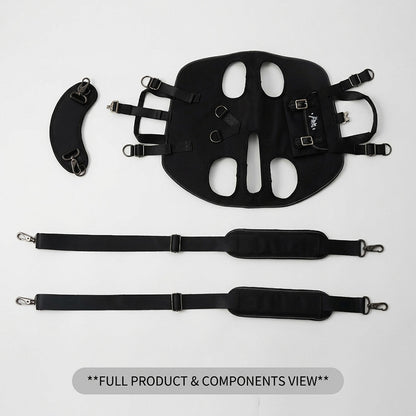 Flat lay overhead view of all PawsMore dog carrier backpack components on white background including the main black Oxford fabric carrier body panel with ergonomic leg cutouts, metal D-rings and buckle hardware, two padded adjustable nylon shoulder straps with metal snap hooks, and one curved padded waist support strap — complete contents of the hands-free 3-in-1 dog backpack carrier set