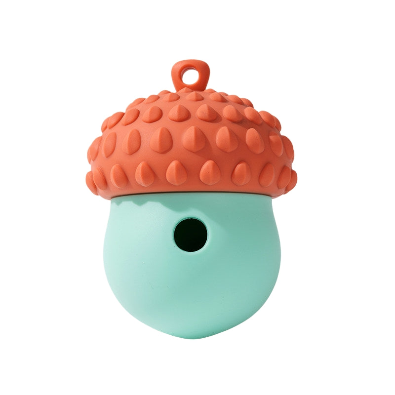 Orange and mint Acorn Dog Treat Dispenser Toy with textured shell and treat hole, isolated on a white background.
