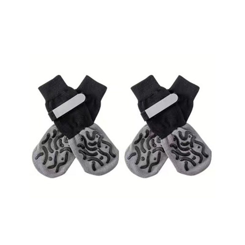 Studio shot on white background of black and gray anti-slip dog socks and leg warmers with textured grip soles.