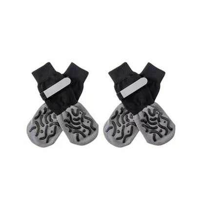 Studio shot on white background of black and gray anti-slip dog socks and leg warmers with textured grip soles.