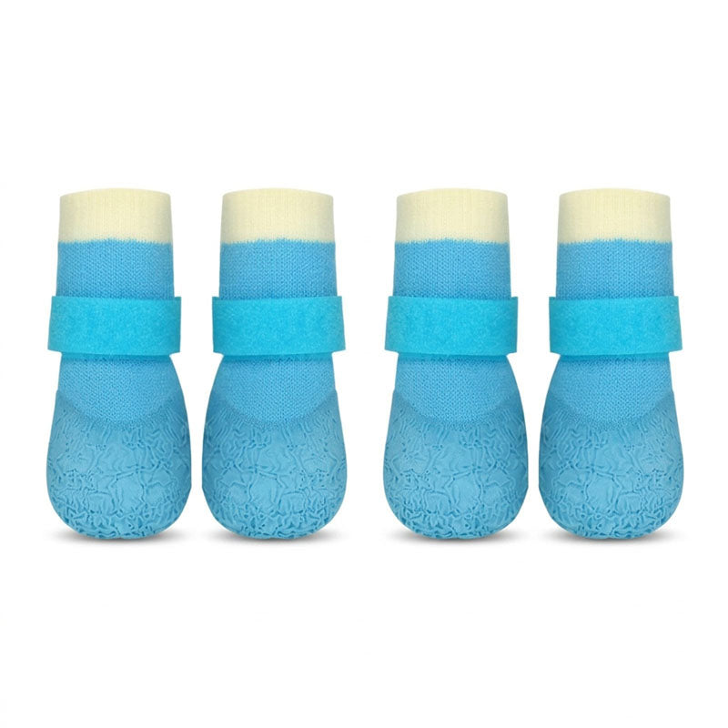 Four blue waterproof anti-slip dog socks with Velcro straps, shown in a clean studio shot on a white background.