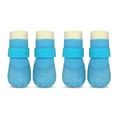 Four blue waterproof anti-slip dog socks with Velcro straps, shown in a clean studio shot on a white background.