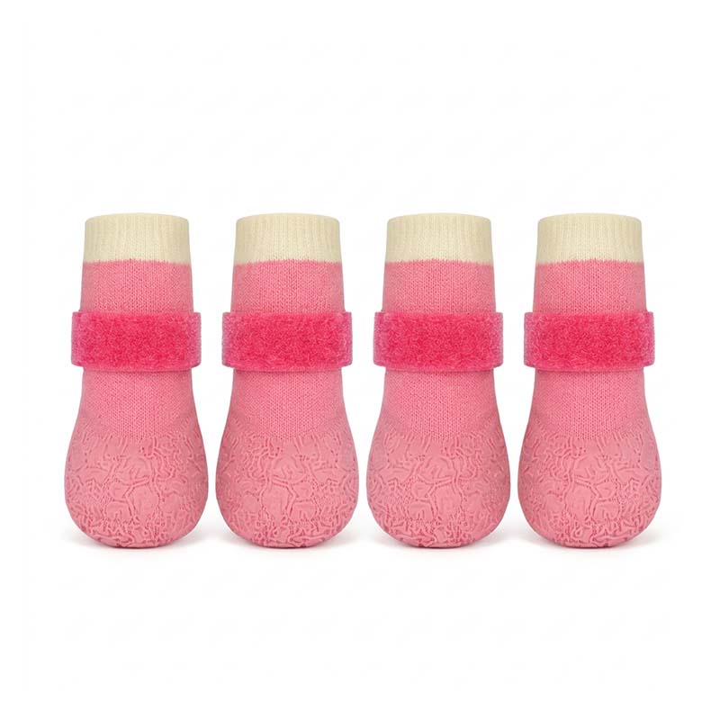 Four pink waterproof anti-slip dog socks with Velcro straps, beige cuffs, on a white studio background.