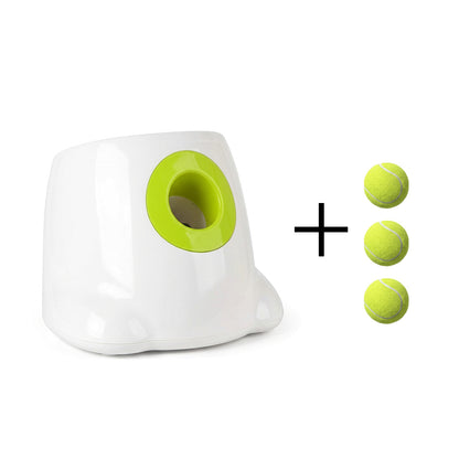 White automatic dog ball launcher with lime green opening and three tennis balls on a white background.