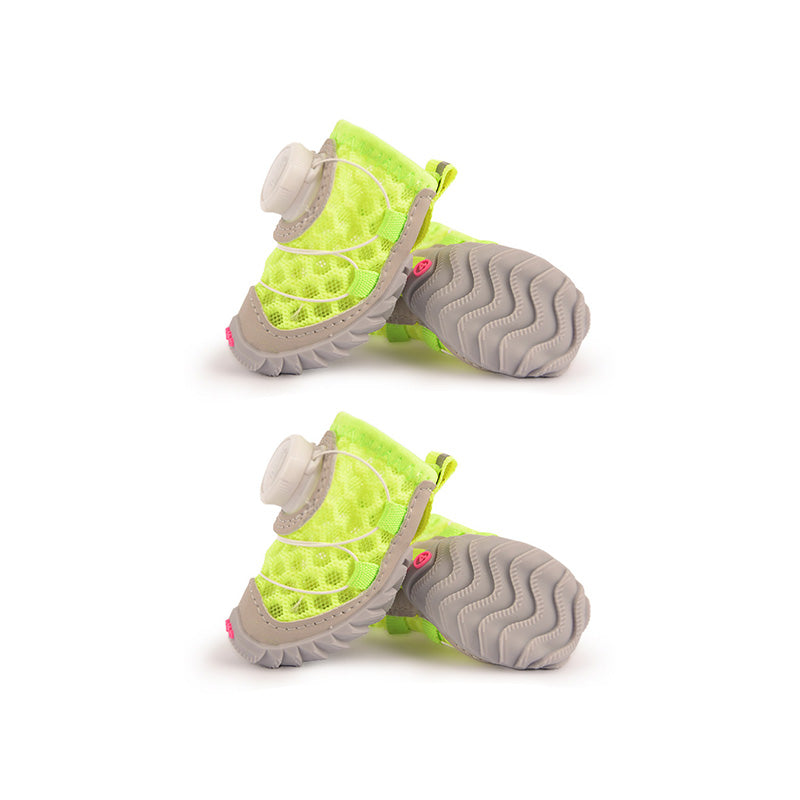 Neon yellow mesh dog shoes with gray tread soles, white cord laces, and quick-dial fasteners.