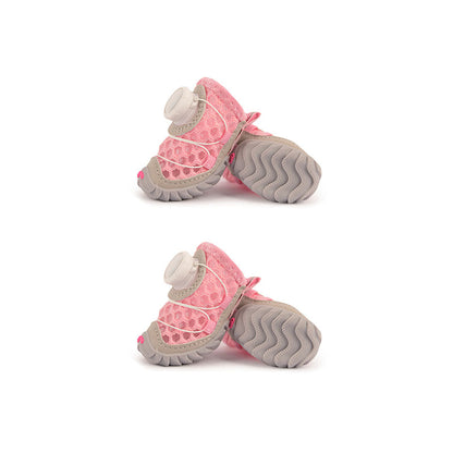 Bubblegum pink mesh dog shoes with gray tread soles and quick-dial fasteners.