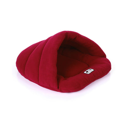 Ruby red fleece pet cave bed with hooded opening and cushioned sleeping-bag shape.