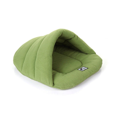 Sage green fleece pet cave bed with raised back, hooded opening, and soft front lip.