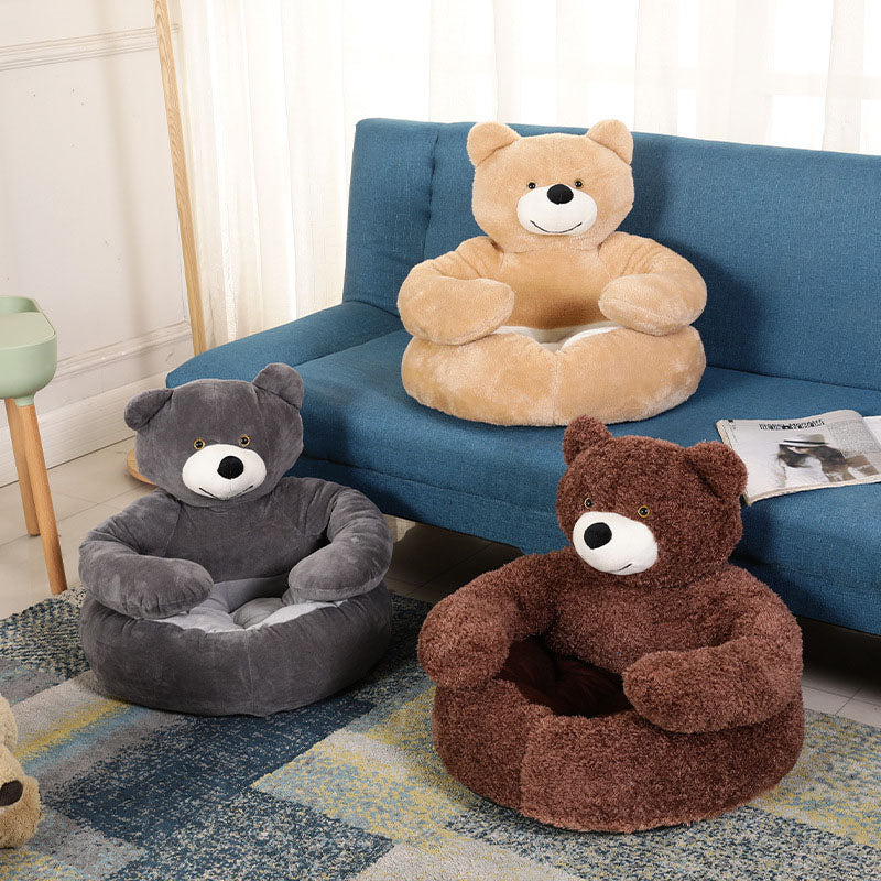Three PawsMore teddy bear hug pet beds in Modern Gray, Light Brown, and Dark Brown displayed in a clean, modern living room setting next to a blue sofa.
