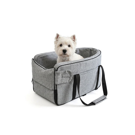 Small white terrier dog sitting comfortably inside a heather grey armrest pet car seat on a white background.