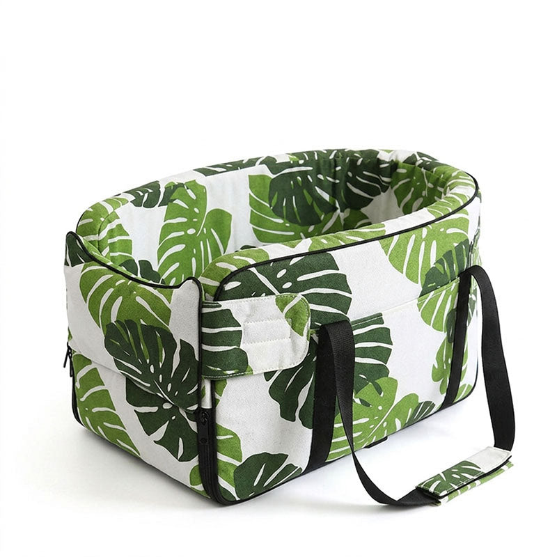 Tropical green monstera leaf print pet car armrest bed with black carrying straps.
