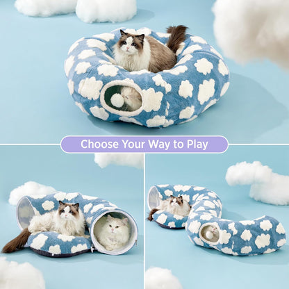 Cloud Donut Cat Tunnel Bed in donut form on a pastel blue studio set with a Ragdoll on top and a Persian curled in the tunnel.