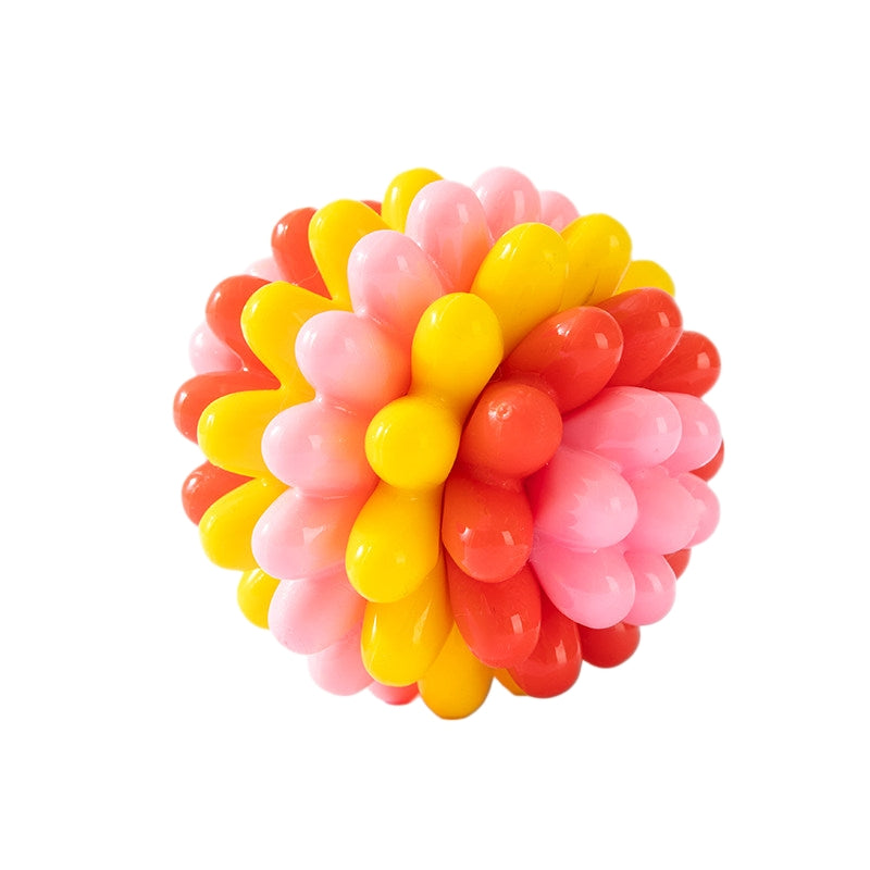 Colorful spiky Durable TPR rubber dog ball in pink, yellow, and red on a white background.