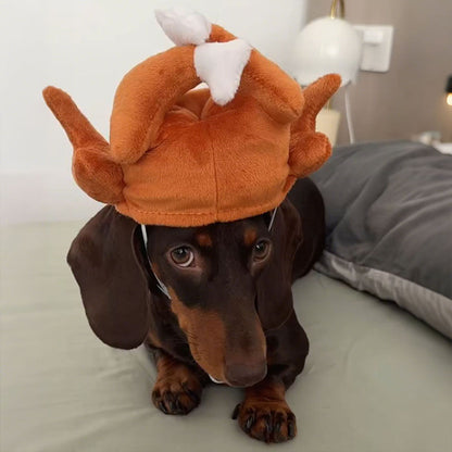 Dachshund wearing a roasted turkey plush pet costume hat with elastic chin strap.