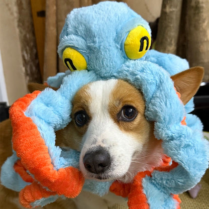 A cute Corgi wearing a blue giant octopus plush dog toy like a hat, showing the realistic tentacles and soft crinkle paper features.