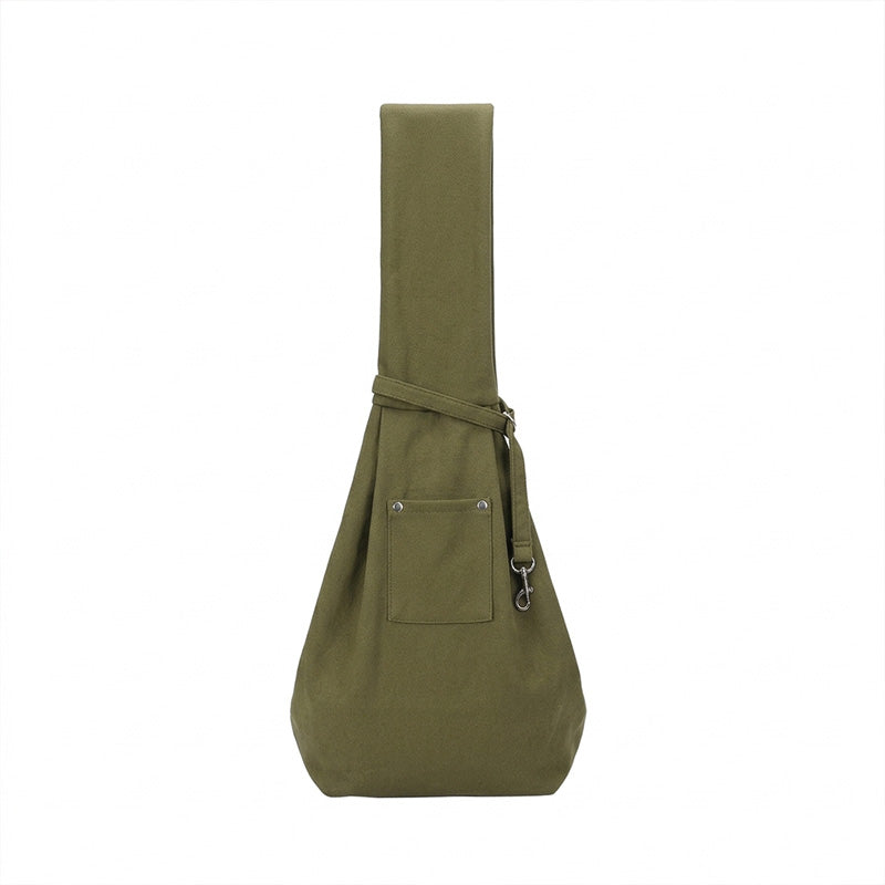 Sage green pet sling carrier with front pocket, safety clip, and wide shoulder strap.