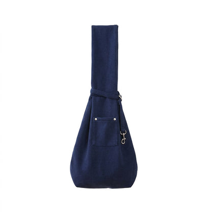 Navy blue pet sling carrier shown on a white studio background with crossbody strap.