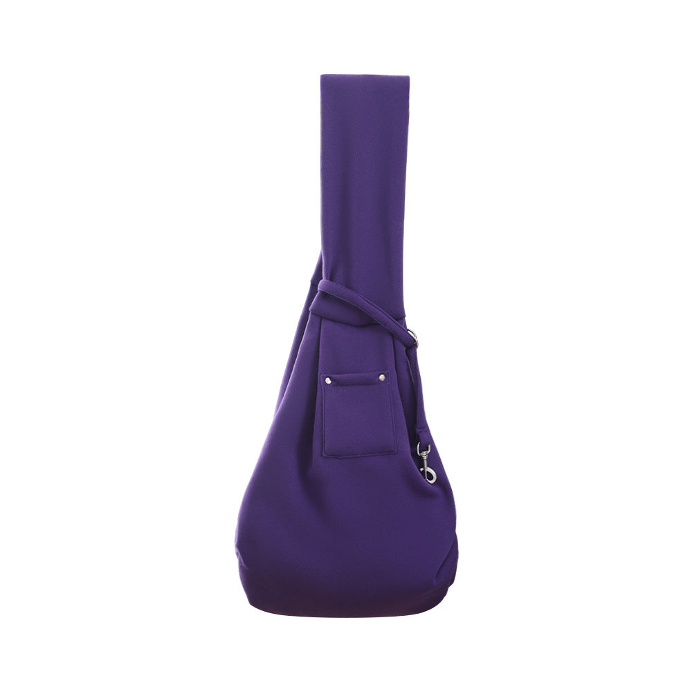 Lavender purple pet sling carrier with wide strap, front pocket, and soft pouch shape.