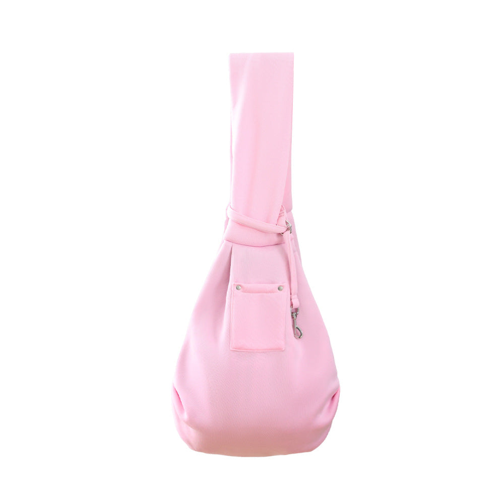 Blush pink pet sling carrier with front pocket and adjustable crossbody strap.