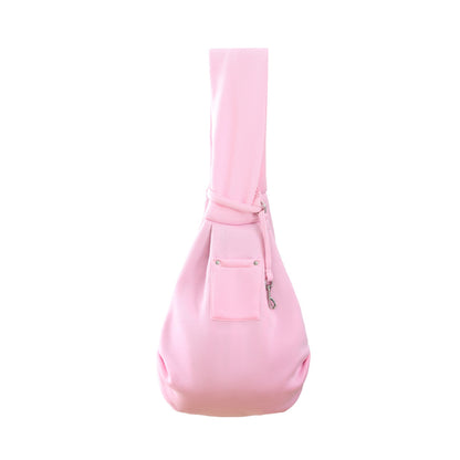 Blush pink pet sling carrier with front pocket and adjustable crossbody strap.