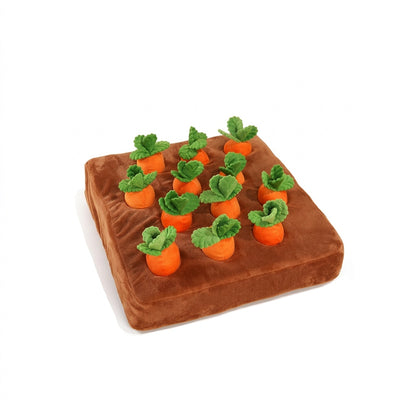Plush brown Interactive Carrot Patch Dog Puzzle Toy with orange carrots and green leaves on a white background.