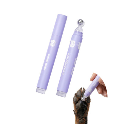Lavender pet paw and nose balm roller with metal rollerball shown applying balm to a dog paw.