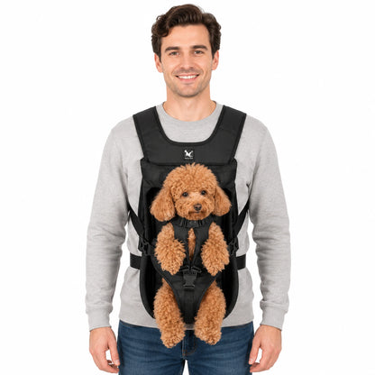 Black front-facing pet carrier worn by model with small brown poodle