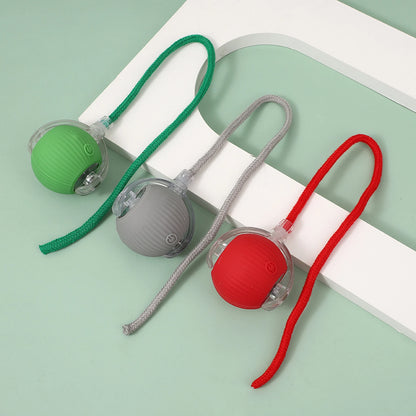 Green, gray and red cat balls with matching rope tails on a pale green background.