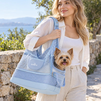 Woman carrying a Yorkshire Terrier in the Sky Blue mesh shoulder pet carrier on an outdoor path