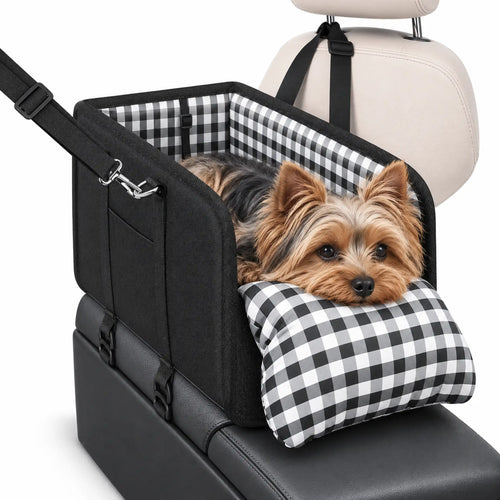 Yorkshire Terrier resting in a black console dog car seat with a gingham chin cushion on white.