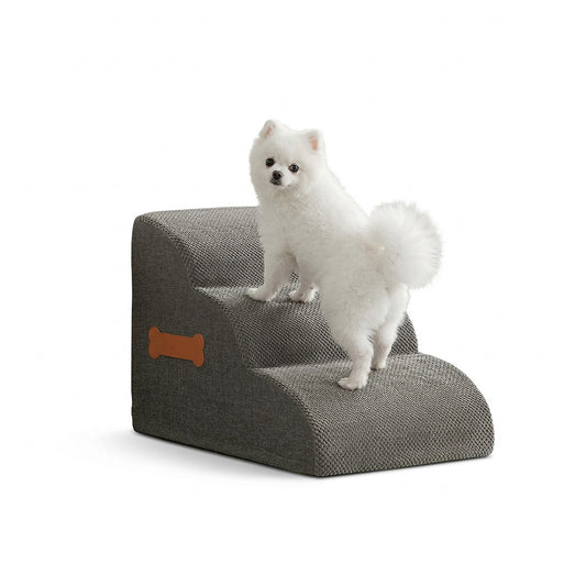 Fluffy white Pomeranian dog confidently climbing a modern, slip-free grey foam pet stair on a white background.
