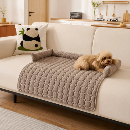 Coffee-brown pet sofa cover with bolster on a beige couch, toy poodle lying on it