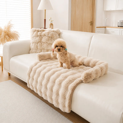 Beige faux-fur pet sofa cover with bolster on a beige couch, toy poodle on it