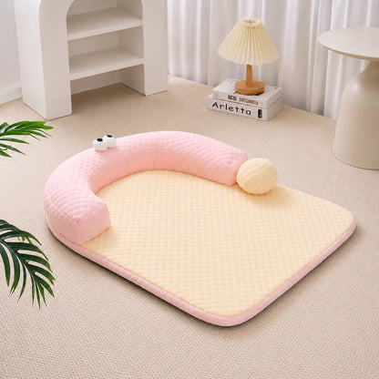 Pastel-pink ice-bead cooling pet bed with C-shaped bolster on a beige carpet