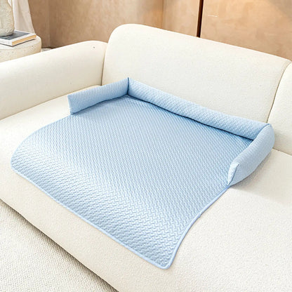 Sky-blue ice-silk cooling pet sofa cover with C-shaped bolster on a cream boucle sofa