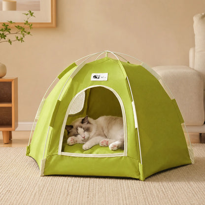 Ragdoll cat sleeping inside a Green foldable pet tent bed