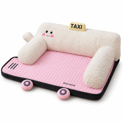 Pink car-shaped pet bed with cream plush bolsters, quilted mat and decorative taxi sign.