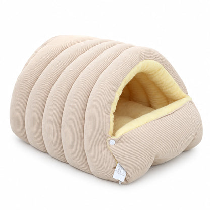 Beige ribbed pet cave bed with cream plush lining and a snapped-up front flap.