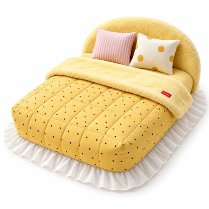 Yellow Dots plush pet bed with a yellow quilt with black dots, two patterned pillows and a white ruffled skirt.