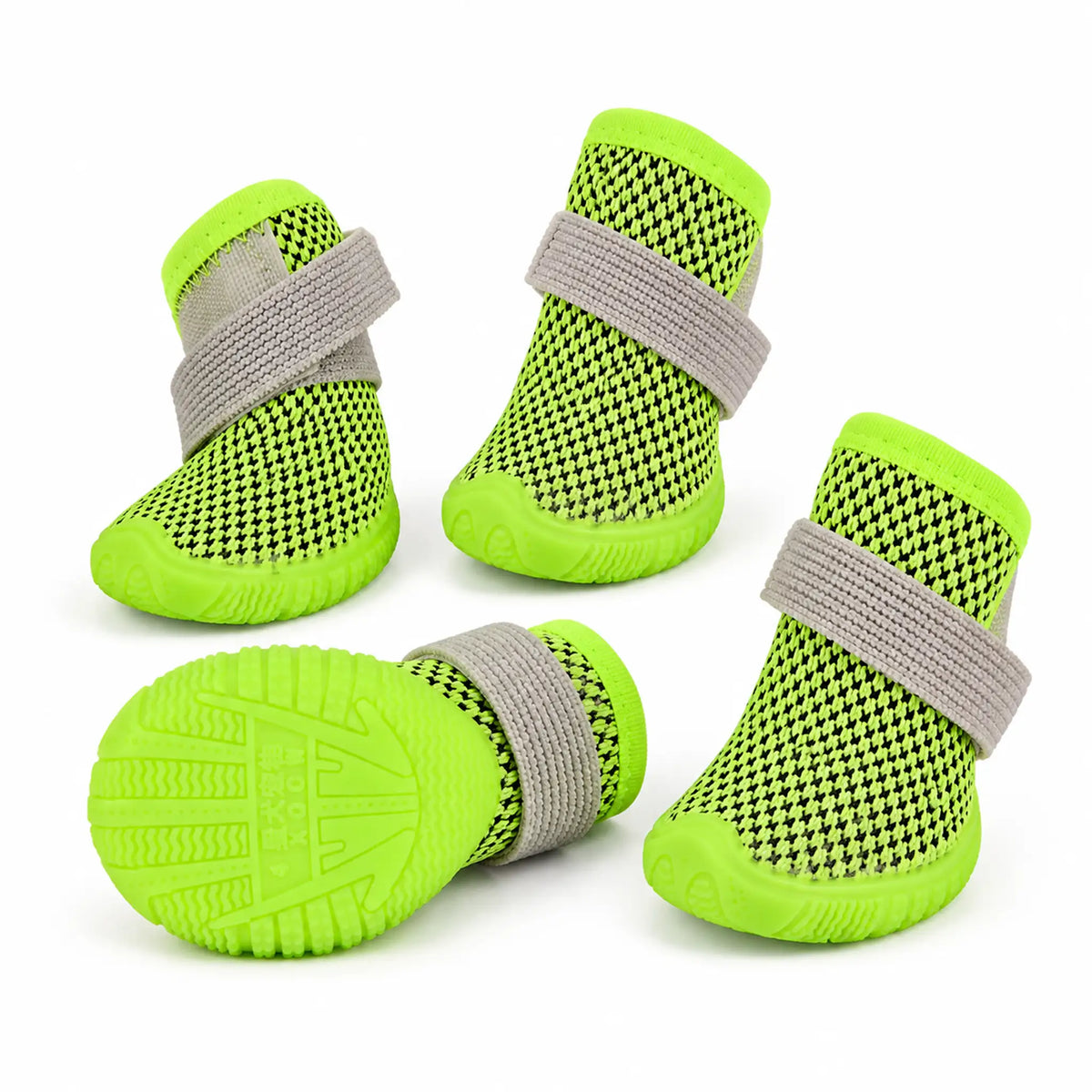 Set of four lime green mesh dog shoes with gray elastic wrap straps and a rubber sole view