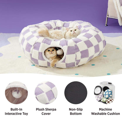 Pastel purple checkered cat tunnel bed feature shot — Sherpa cover, non-slip base, machine-washable cushion, built-in pom-pom toy.