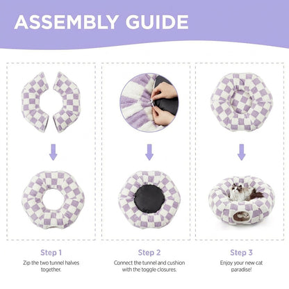 Three-step assembly guide for the pastel purple checkered cat tunnel bed: zip halves, attach cushion via toggles, ready to use.