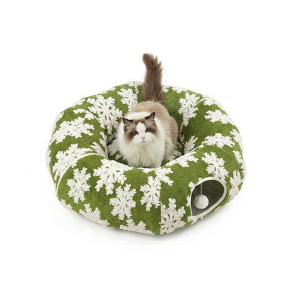 Forest Green Snowflake variant — cat curled in the center cushion of the green snowflake donut cat tunnel bed.