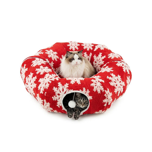 Festive Red Snowflake variant — Ragdoll cat resting on top of the donut tunnel bed, second cat peeking from the tunnel entrance.