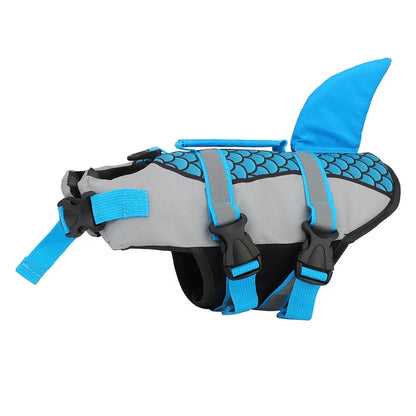 Gray and blue shark fin dog life jacket on a white background, with adjustable straps and black buckles.