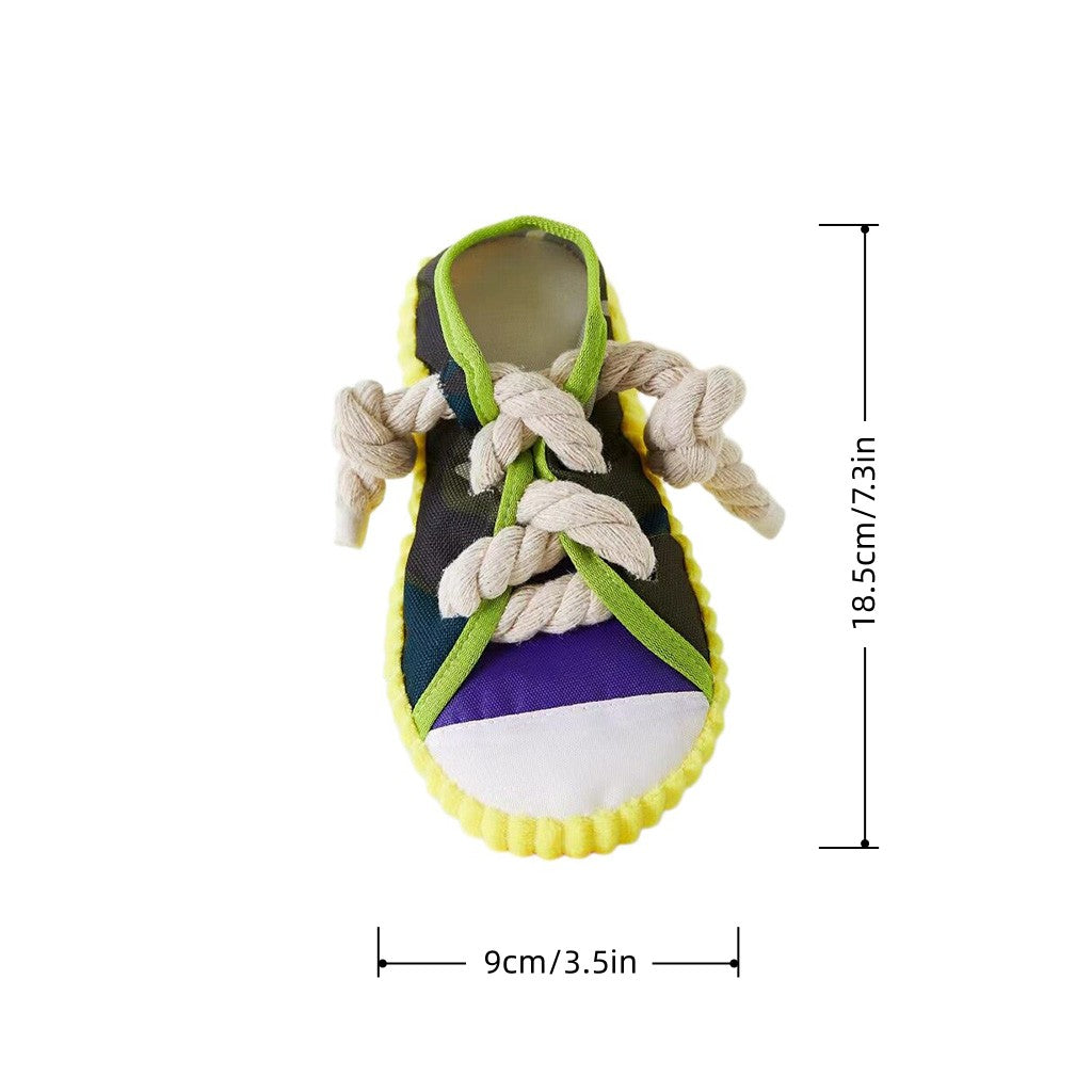 Studio shot on a white background of a colorful squeaky sneaker dog toy with rope knot laces, shown as 18.5cm tall.