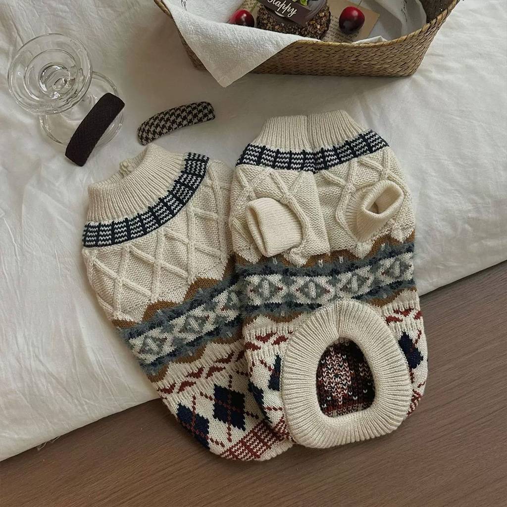 Two oat beige Fair Isle knit pet sweaters showing sleeve openings, belly opening, and ribbed hems.
