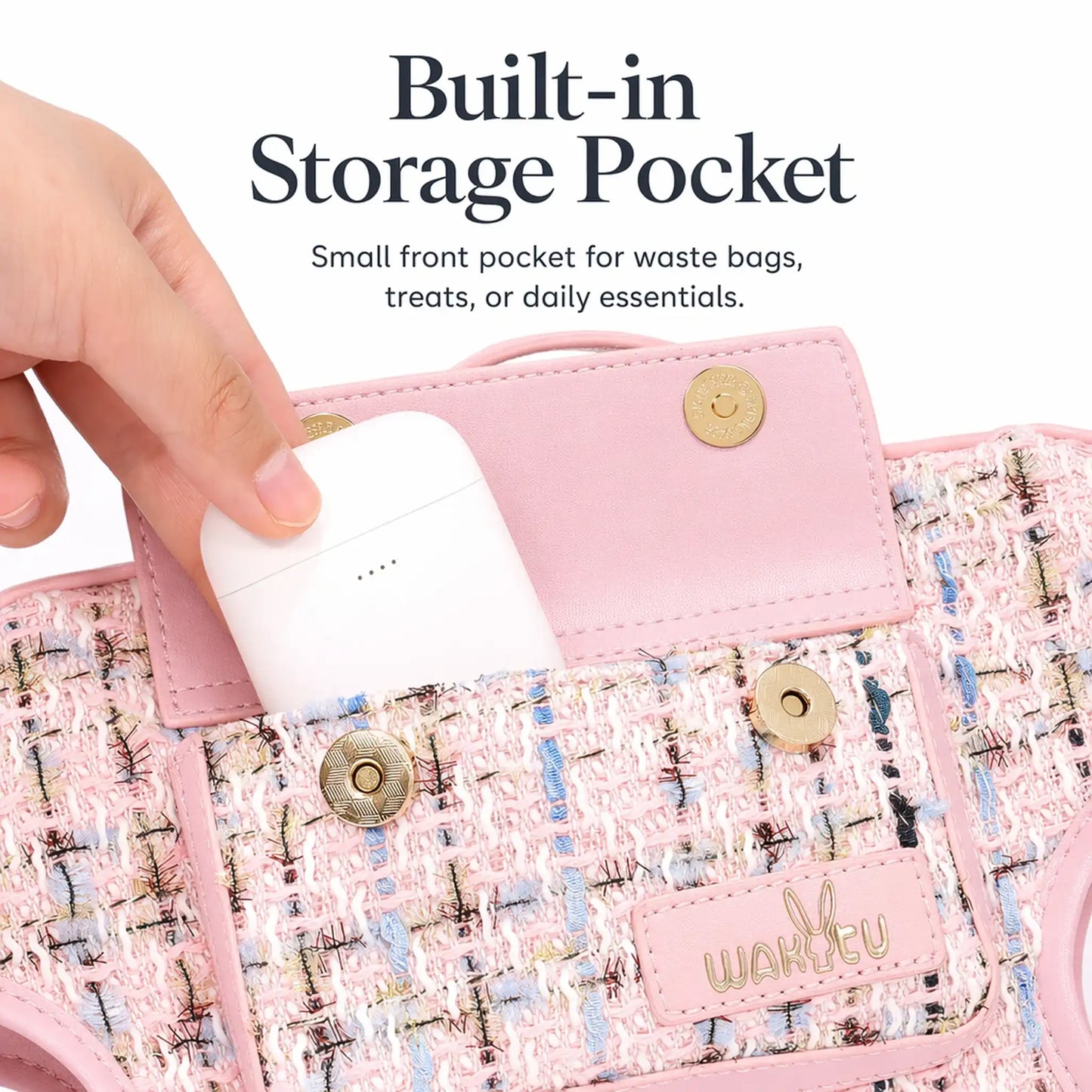 Front magnetic-snap pocket on pink tweed dog carrier harness opened to hold a wireless earbud case