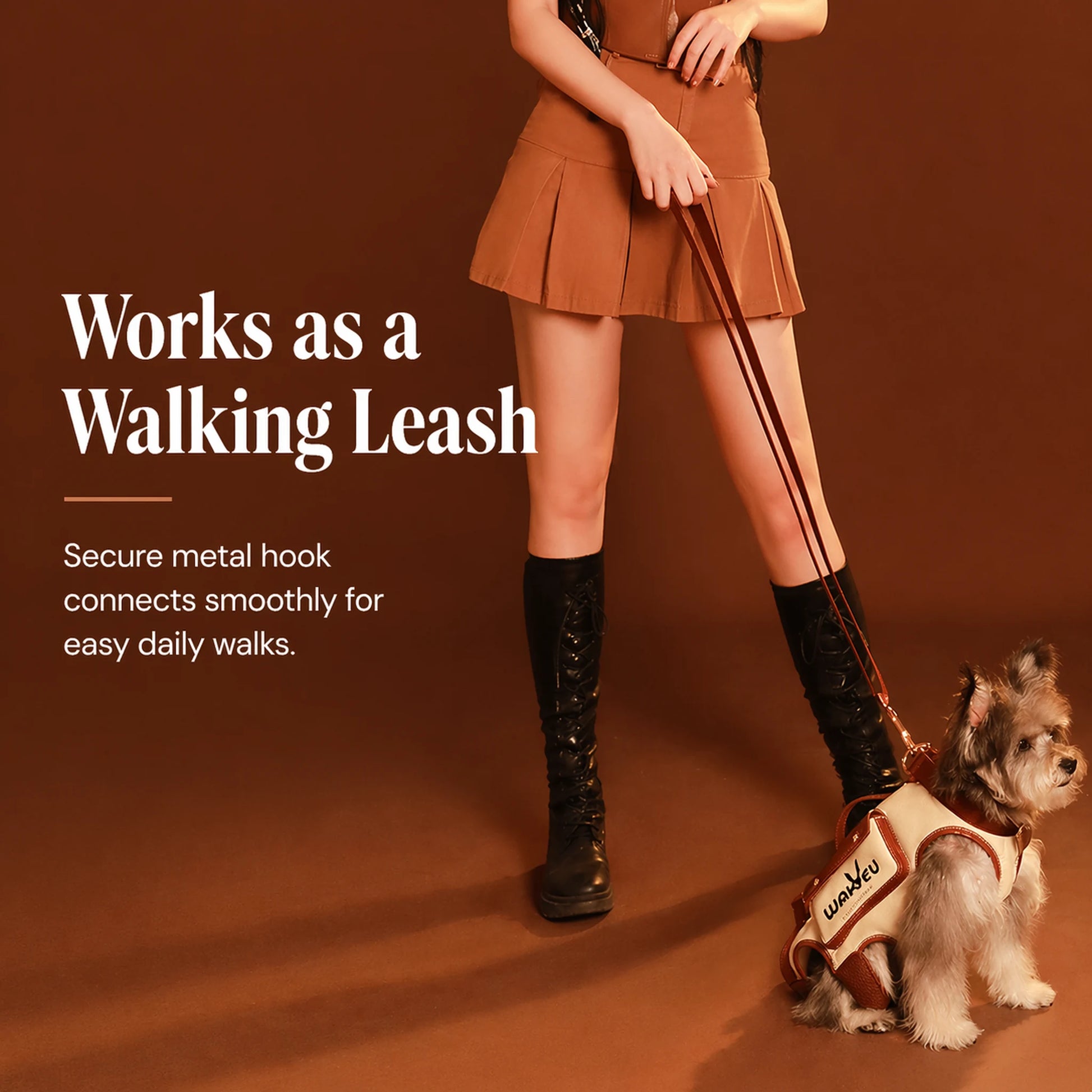 Woman walking a small dog using the cream carrier harness with integrated metal-hook leash